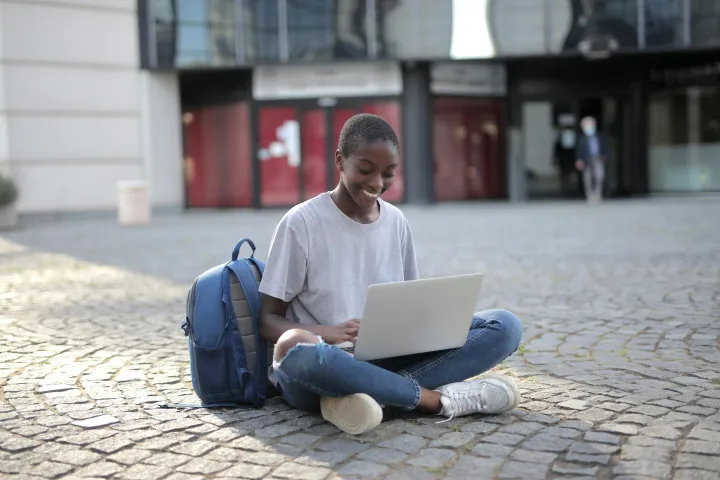 Girl using laptop in a public space