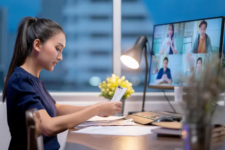 Girl attending live virtual classroom taking notes